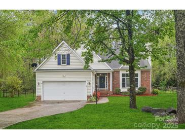 Charming two-story home with a brick and siding facade, lush lawn, and an attached two-car garage at 11333 Snapfinger Dr, Charlotte, NC 28277