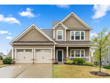 Charming two-story home featuring a welcoming front porch and a spacious three-car garage at 1430 Whitman Ct, York, SC 29745