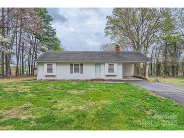 Charming ranch home with a well-maintained front lawn and convenient carport at 209 Vanderbilt Ave, China Grove, NC 28023