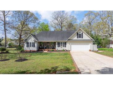 Charming single-Gathering home with a well-manicured lawn, a cozy front porch, and an attached garage at 2987 Irish St, Newton, NC 28658