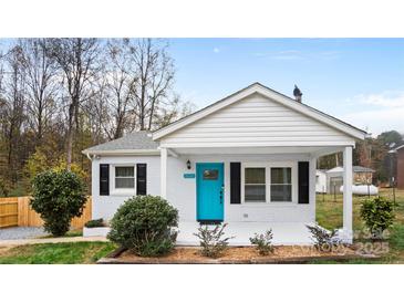 Charming home featuring a blue front door, white painted brick, and a cozy front porch at 318 Lake Montonia Rd, Kings Mountain, NC 28086