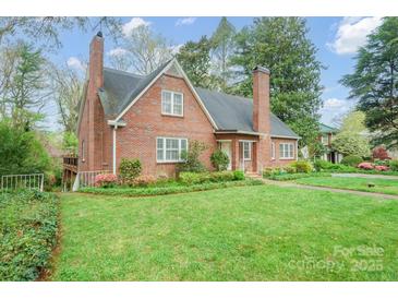 Charming two-story brick home with a landscaped lawn, mature trees, and inviting curb appeal at 431 Sullivan Rd, Statesville, NC 28677