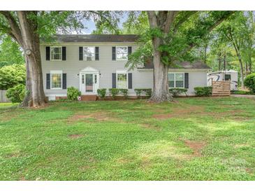 Charming two-story home with mature trees, black shutters, and a well-manicured lawn at 511 Plymouth Ave, Salisbury, NC 28144
