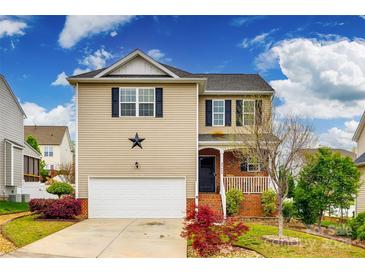 Charming two-story home with a well-manicured lawn and inviting curb appeal on a sunny day at 5664 Norwood Ridge Dr, Rock Hill, SC 29732