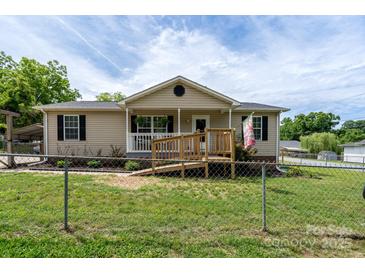 Charming single-story home with a welcoming front porch and ramp, surrounded by a well-maintained lawn at 907 Bethpage Rd, Kannapolis, NC 28081