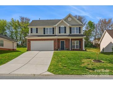 Charming two-story home with brick accents, well-maintained lawn, and a spacious two-car garage at 10107 Atkins Ridge Dr, Charlotte, NC 28213