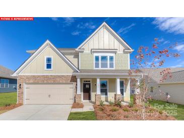 Charming two-story home with stone accents, a welcoming front porch, and an attached two-car garage at 152 Ventor Way, Mooresville, NC 28115