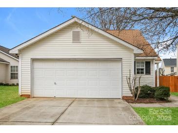 Attached one-car garage with white door and neutral vinyl siding at 1671 Sandpiper Dr, Rock Hill, SC 29732