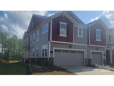 Beautiful townhome with stone accents, two-car garage, and neutral siding at 2005 Vinyasa Ln # Sts-45, Charlotte, NC 28215