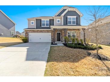 Charming two-story home featuring a stone and siding exterior, a two-car garage, and a well-manicured front lawn at 2031 Killian Creek Dr, Denver, NC 28037