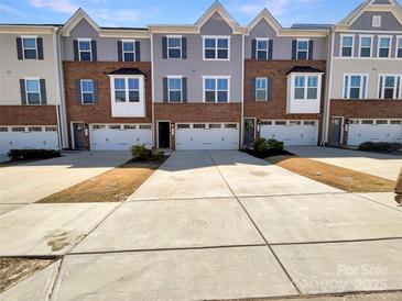 Charming townhouse exteriors with driveways and beautiful architectural details at 2557 Grantham Place Dr, Fort Mill, SC 29715
