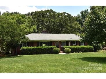Charming brick ranch with manicured lawn and mature landscaping, perfect for outdoor enjoyment at 8608 Cedarbrook Dr, Charlotte, NC 28215