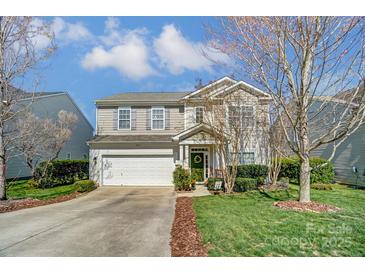 Two-story home featuring a well-maintained lawn and attached two car garage at 10421 Dominion Village Dr, Charlotte, NC 28269