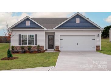 Charming single-Gathering home with a two-car garage, stone accents, and blue trim details at 129 Jacobs Hill Pl, Troutman, NC 28166
