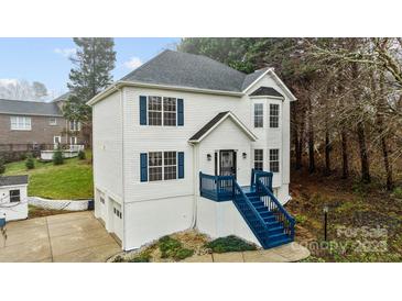 Charming two-story home with blue shutters and a matching blue staircase leading to the front door at 5680 Gold Creek Bay None, Hickory, NC 28601