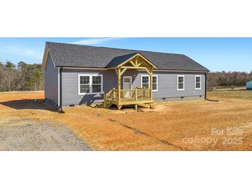New construction home featuring gray siding, a dark gray roof, and a charming, covered front porch at 629 Mt. Wesley Church Rd, Hiddenite, NC 28636