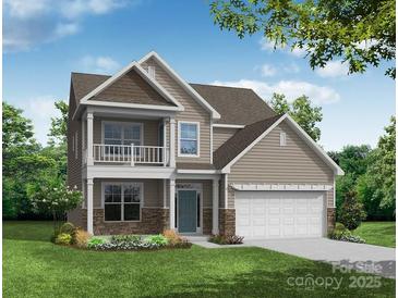 Charming two-story home boasting a covered front porch, well-manicured lawn, and attached two-car garage at 8622 Frank Grier Rd # 57, Charlotte, NC 28215