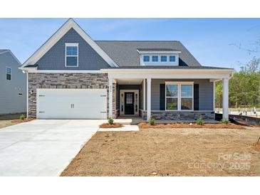 Charming single-Gathering home featuring a stone facade, white garage door, and inviting front porch at 896 Exeter Dr, Sherrills Ford, NC 28673