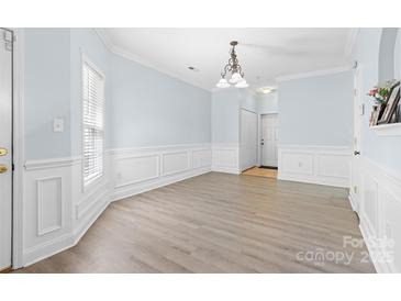 Bright dining room featuring elegant chandelier, chair rail, and neutral flooring at 1386 21St Ne Ave, Hickory, NC 28601