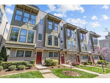 Modern townhome exterior with large windows, stylish trim, and well-maintained landscaping on a sunny day at 1617 Cannon View Ln, Charlotte, NC 28208