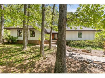 Charming single-Gathering home with beautiful landscaping, mature trees, and a welcoming front porch at 21 Hollyberry Woods, Lake Wylie, SC 29710