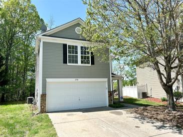 Charming two-story home featuring a attached garage, neutral siding, and manicured lawn at 2752 Bramble Ridge Ct, Charlotte, NC 28215