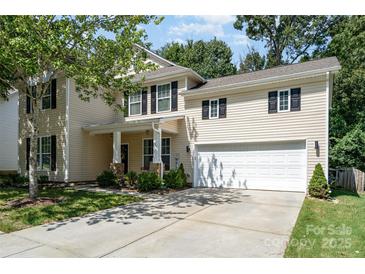 Charming two-story home featuring a well-manicured lawn and attached two-car garage at 3009 Early Rise Ave, Indian Trail, NC 28079