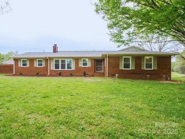 Charming brick home with a well-manicured lawn and beautiful landscaping at 3452 Flat Creek Rd, Lancaster, SC 29720