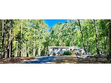 Charming single-story home nestled in a serene wooded setting at 368 Northwood Dr, Troy, NC 27371