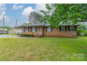 Charming single-story brick home featuring shuttered windows and a well-maintained lawn at 417 Donna Ave, Gastonia, NC 28052