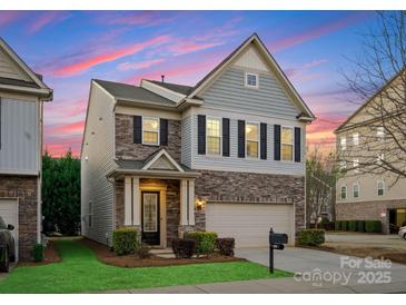 Charming two-story home featuring a stone facade, well-manicured lawn, and an attached two-car garage at 6020 Union Pacific Ave, Charlotte, NC 28210