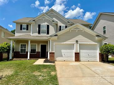 Charming two-story home with a well-manicured lawn, two-car garage and classic architectural details at 9419 Seamill Rd, Charlotte, NC 28278