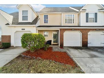 Charming townhome exterior with a well-manicured lawn and inviting entrance at 10920 Walking Path Ln, Charlotte, NC 28213
