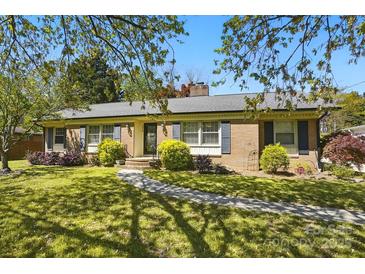 Charming brick home with a well-manicured lawn, mature landscaping, and inviting walkway at 110 Tanglewood Dr, Kannapolis, NC 28081