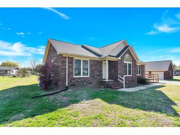 Charming brick home featuring a well-manicured lawn and traditional architectural details at 115 Green Sw St, Concord, NC 28027