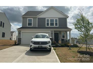 Charming two-story home featuring a gray exterior, two-car garage, and inviting front porch at 120 Parson Ln, Statesville, NC 28625