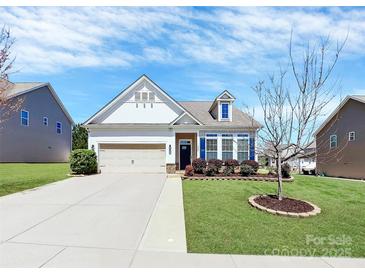Charming single-Gathering home with a manicured lawn, blue shutters, and an attached two-car garage at 1224 Horsesugar Rd, Clover, SC 29710