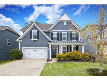 Charming two-story home features a well-manicured lawn and a classic architectural design at 136 Morgans Branch Rd, Belmont, NC 28012