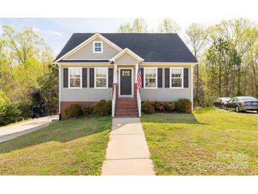 Charming home featuring a brick foundation, light siding, black shutters, and an inviting front entrance at 1527 Meadow Glen Ln, Rock Hill, SC 29730