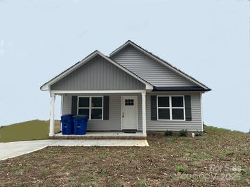 Charming one story home with gray siding, a small front porch, and dark gray shutters at 42 Solomon St, Wadesboro, NC 28170