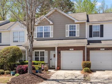 Charming two-story townhome with a well-manicured lawn and an attached one-car garage at 475 Delta Dr, Fort Mill, SC 29715
