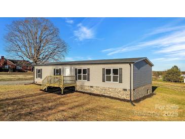 Charming single-story home showcasing a cozy front porch and neutral-tone siding at 501 Mt. Wesley Church Rd, Hiddenite, NC 28636