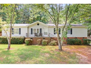 Charming single-story home with a well-maintained front yard, porch, and lush green trees, perfect for peaceful suburban living at 6575 Charlotte Hwy, York, SC 29745