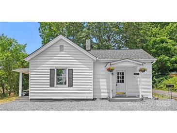 Charming white home featuring a cozy front porch with hanging flower baskets at 806 Grace St, Kings Mountain, NC 28086