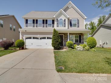 Charming two-story home with a manicured lawn and a spacious two-car garage at 848 Wingthorn Rose Dr, Gastonia, NC 28056