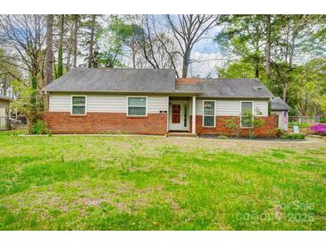 Charming single-story home featuring a brick foundation and well-manicured front lawn at 1212 Robinhood Cir, Charlotte, NC 28227
