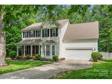 Charming two-story home with black shutters, brick accents and a lush green lawn at 15001 Arrowgrass Way, Charlotte, NC 28278