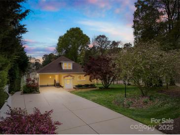 Charming home showcasing a manicured lawn, mature trees, and a long driveway leading to a lovely facade at 158 Regency Rd, Mooresville, NC 28117