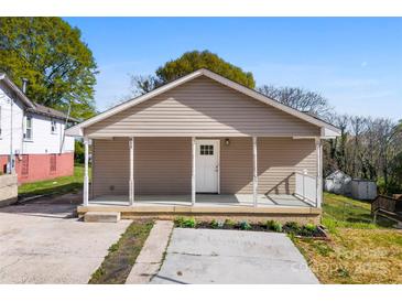 Charming home featuring neutral siding, a cozy front porch, and a well-manicured lawn at 416 E Park Ave, Gastonia, NC 28054