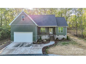 New construction home with a charming facade, attached garage, and a stone driveway lined by tall trees at 472 Oak Rd # 114/115/116, Norwood, NC 28128